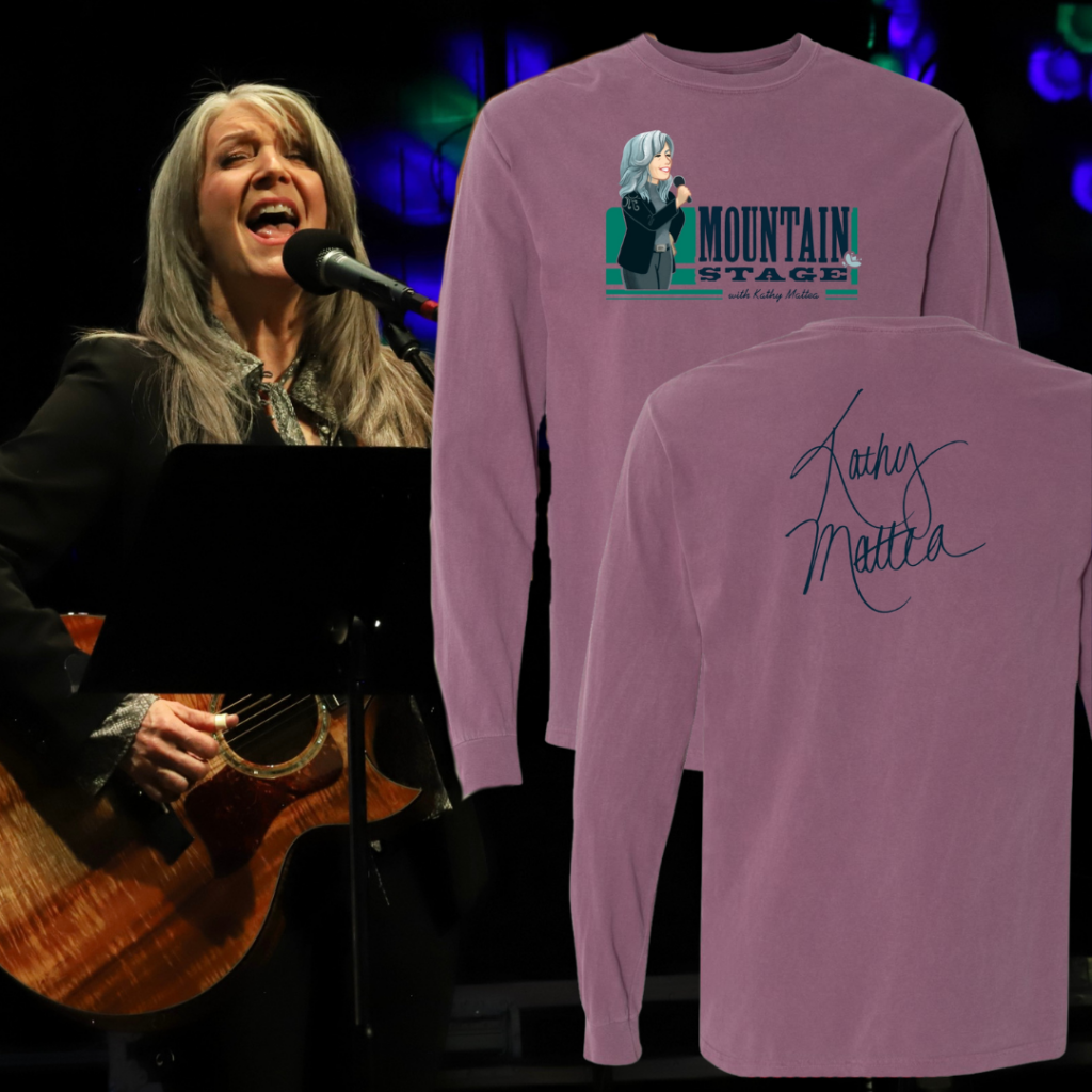 A woman with grey hair sings and plays the guitar. An image of a shirt design is imposed on the photo.